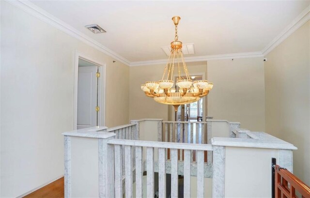 interior space featuring an inviting chandelier, wood-type flooring, and ornamental molding