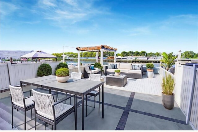 view of patio with a water view and an outdoor living space