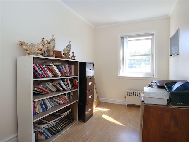 office with radiator heating unit, light hardwood / wood-style floors, and ornamental molding