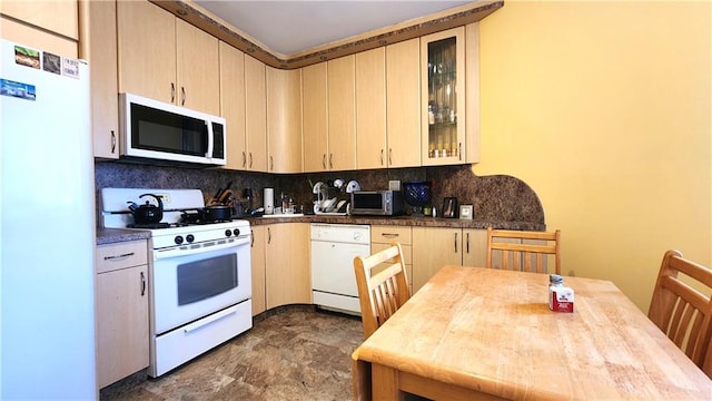 kitchen with white appliances and backsplash