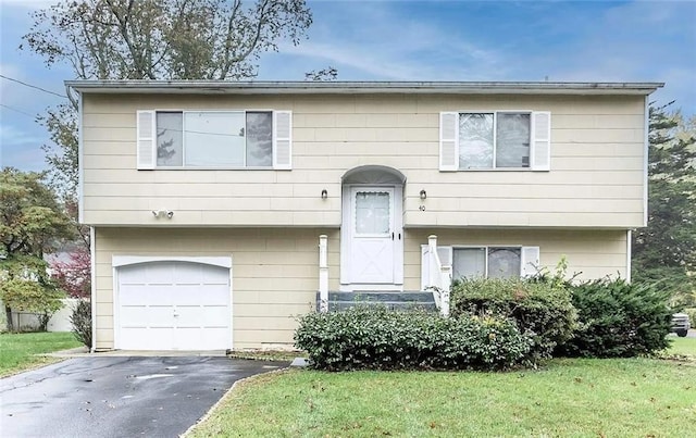 bi-level home with a front lawn and a garage