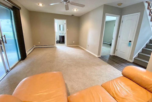 living room with ceiling fan, baseboard heating, and carpet