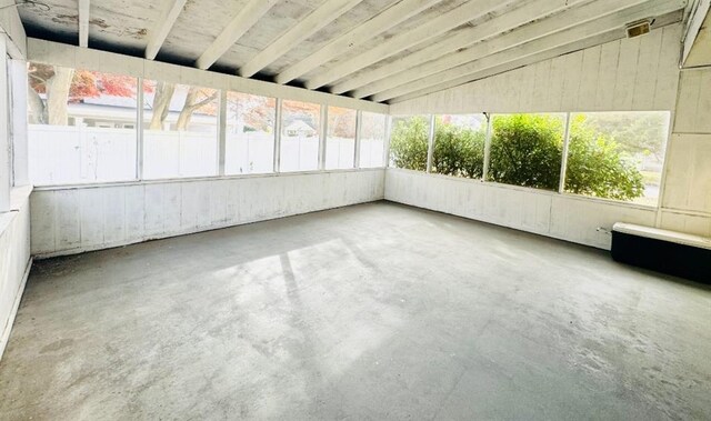 unfurnished sunroom with lofted ceiling