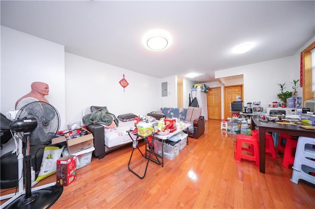 living room with electric panel and light hardwood / wood-style flooring