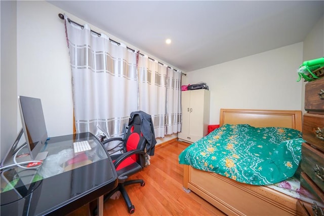 bedroom with hardwood / wood-style flooring