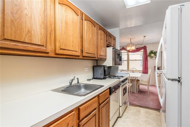 kitchen featuring sink and white appliances