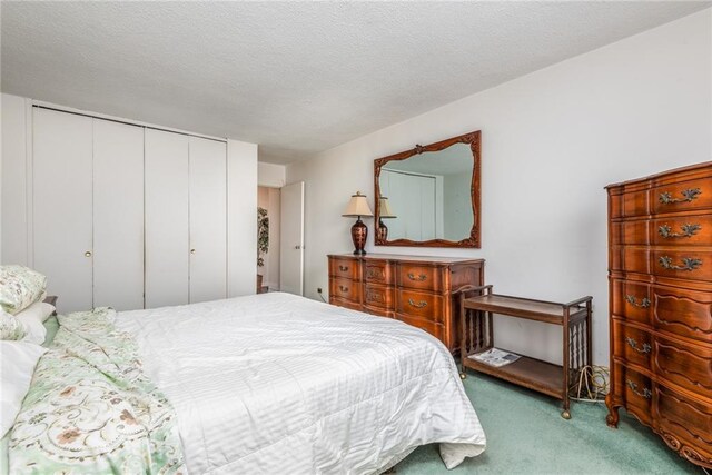 carpeted bedroom with a textured ceiling