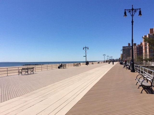 view of community featuring a beach view and a water view