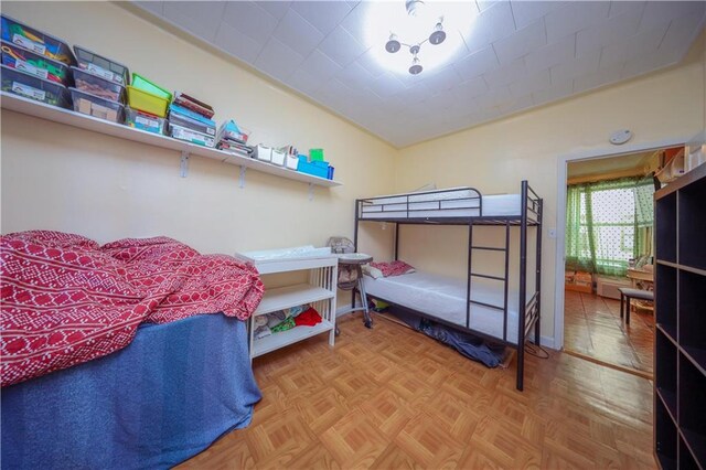 bedroom featuring parquet flooring