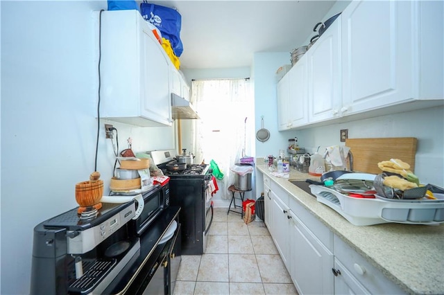 kitchen featuring light countertops, light tile patterned floors, white cabinets, stainless steel range with gas cooktop, and under cabinet range hood