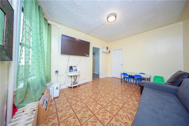 1516 W 5th St, Brooklyn, NY 11204 - living room featuring a textured ceiling and baseboards