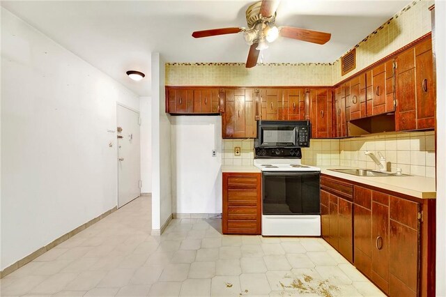 kitchen with tasteful backsplash, sink, electric range, and ceiling fan