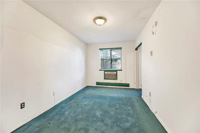 unfurnished room featuring carpet floors, baseboards, a baseboard heating unit, and a wall mounted AC