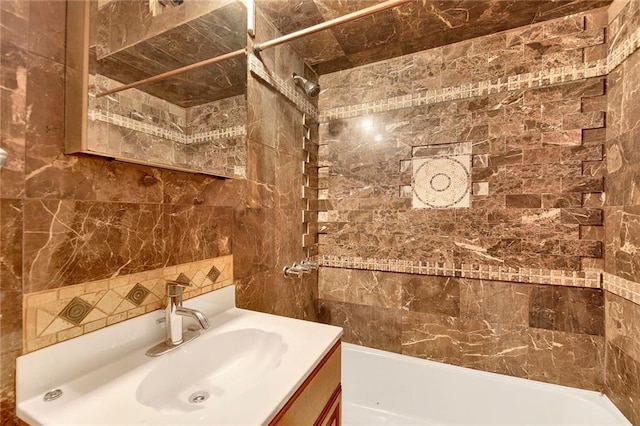 bathroom with vanity, shower / bathing tub combination, and tile walls