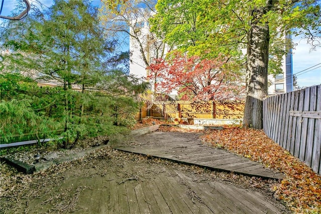 view of yard with a fenced backyard and a deck