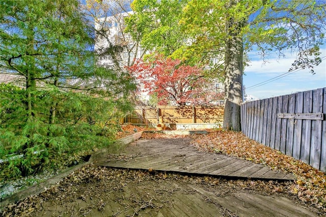 wooden terrace featuring a fenced backyard
