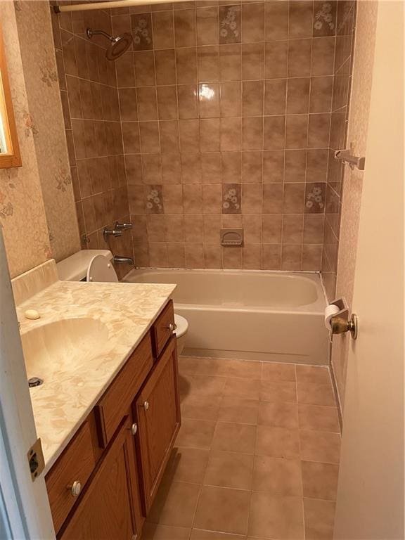 full bathroom with tile patterned flooring, vanity, toilet, and tiled shower / bath