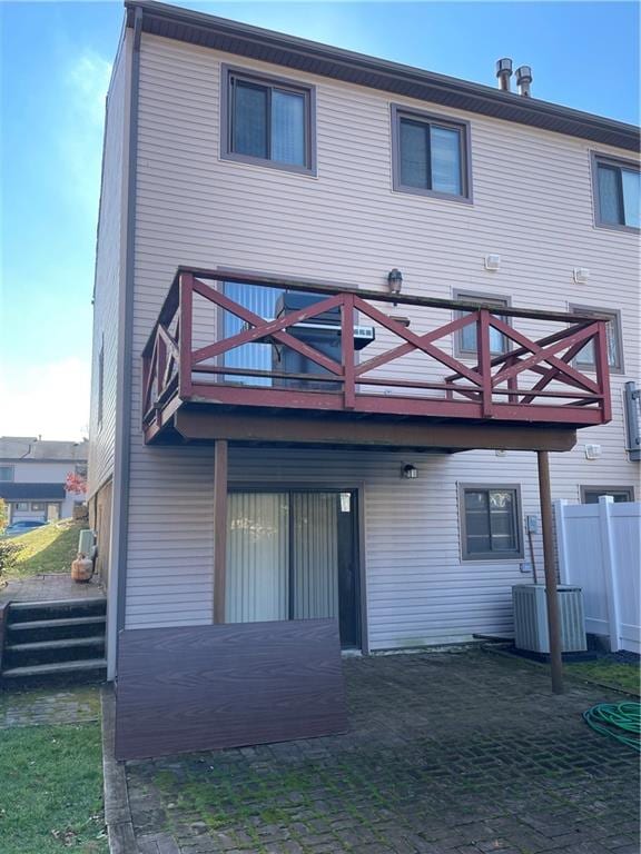 rear view of house with a balcony and central air condition unit