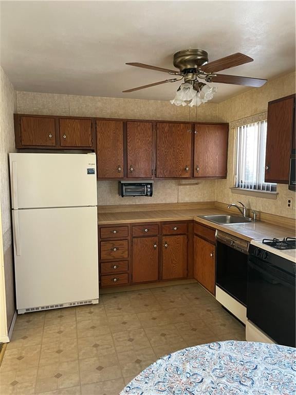 kitchen featuring white appliances, ceiling fan, and sink