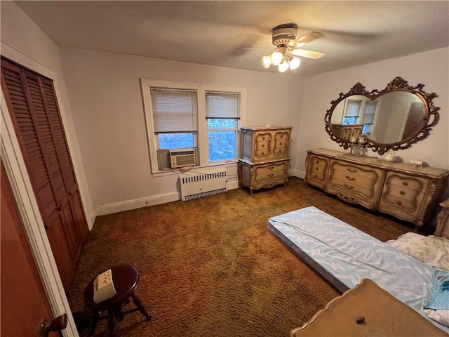 carpeted bedroom with cooling unit, a ceiling fan, radiator heating unit, and baseboards