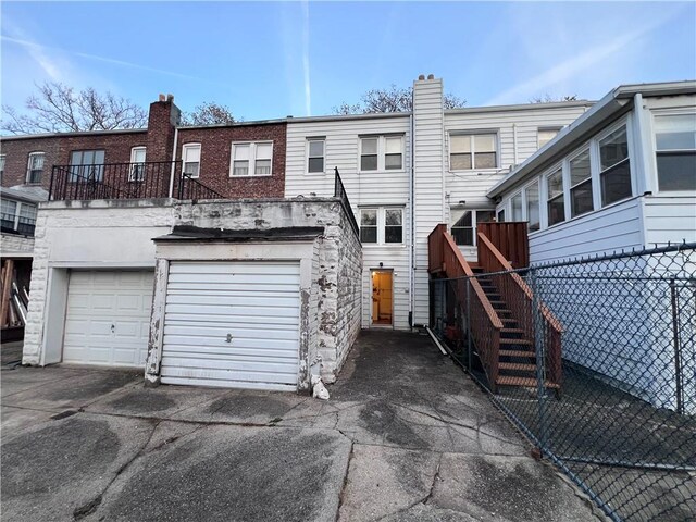 rear view of house with a garage