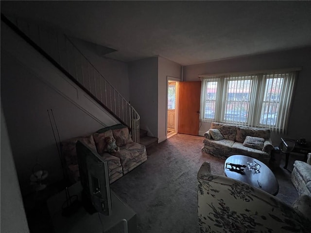 living room featuring stairway and carpet floors