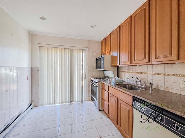 kitchen with a baseboard heating unit, dishwasher, sink, stainless steel range with gas cooktop, and dark stone counters