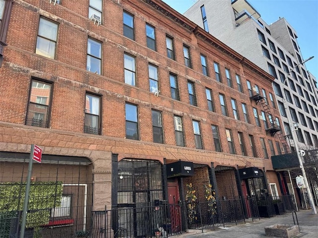 view of building exterior with fence