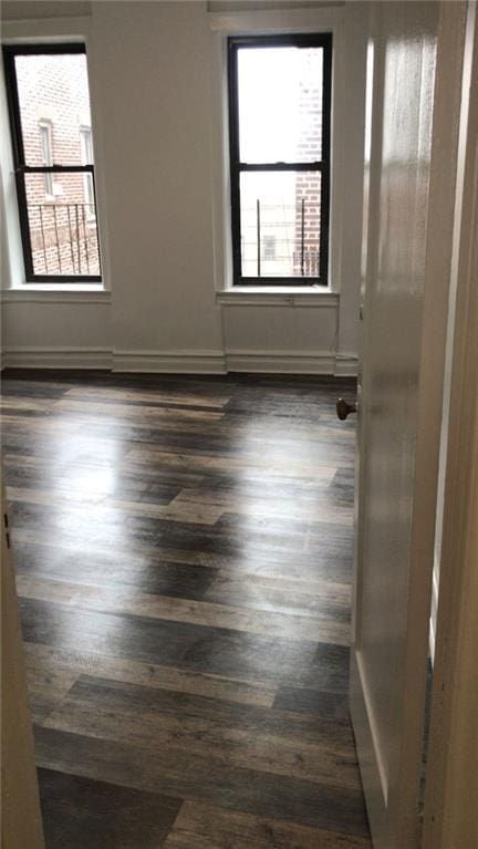 empty room with dark hardwood / wood-style floors