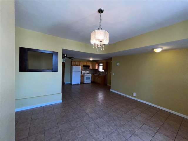 1044 E 96th St, Brooklyn, NY 11236 - unfurnished living room featuring a chandelier, baseboards, and dark tile patterned floors