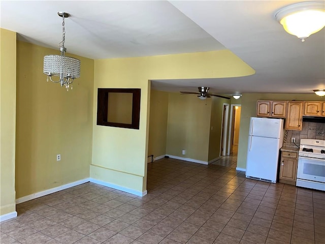 1044 E 96th St, Brooklyn, NY 11236 - kitchen with white appliances, range hood, a chandelier, and baseboards