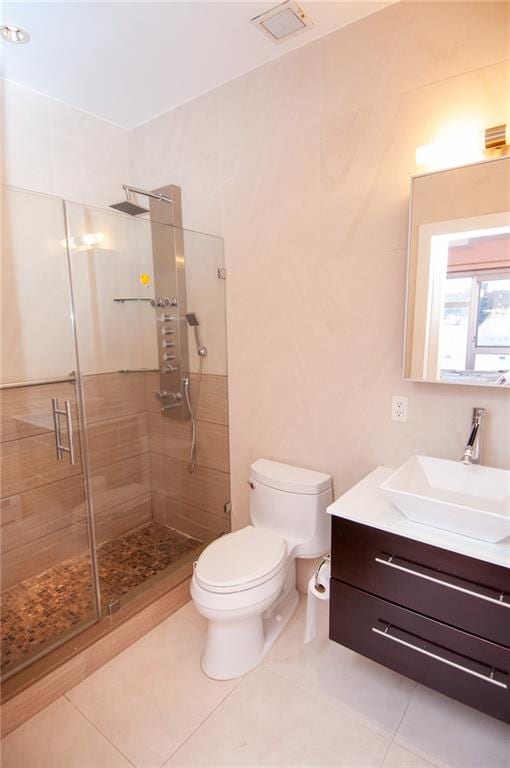 bathroom with toilet, tile patterned floors, an enclosed shower, and vanity