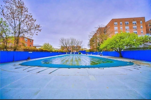 view of pool with a patio area, a fenced in pool, and fence