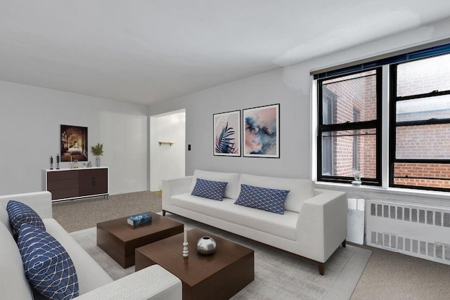 living room featuring light carpet and radiator heating unit