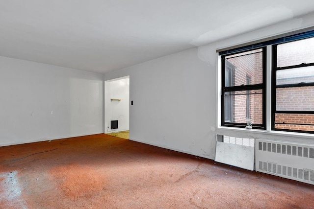 spare room featuring radiator heating unit