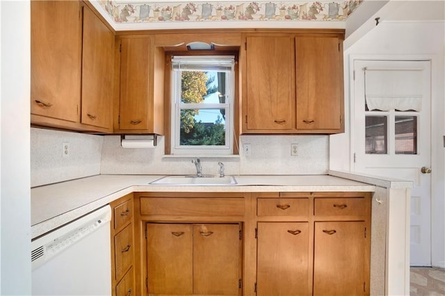 kitchen featuring white dishwasher and sink