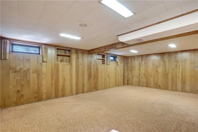 basement featuring carpet and wood walls