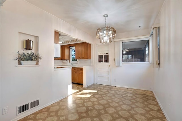 kitchen featuring pendant lighting and an inviting chandelier