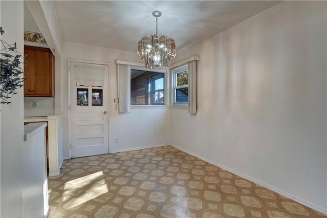 unfurnished dining area with an inviting chandelier