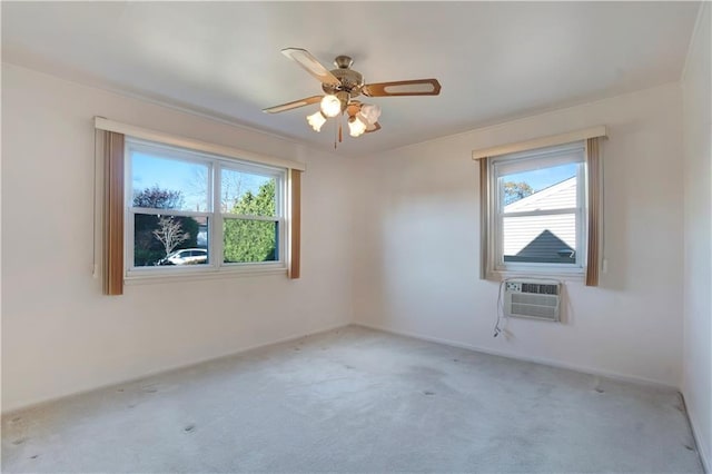 unfurnished room featuring light carpet, a wall unit AC, and ceiling fan