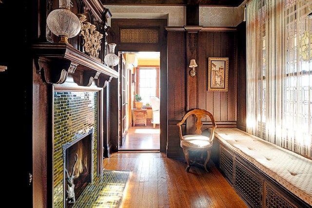 hall featuring hardwood / wood-style floors and wood walls