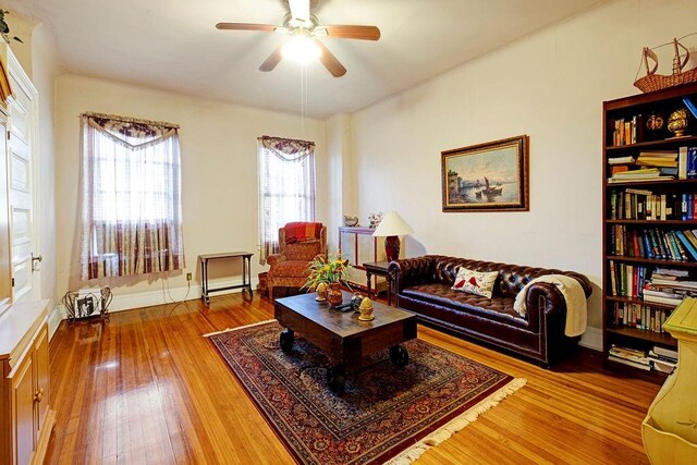 living room with hardwood / wood-style floors, a wealth of natural light, and ceiling fan