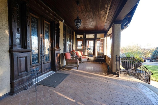 view of patio with french doors and a porch