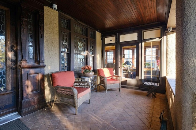 sunroom featuring wooden ceiling