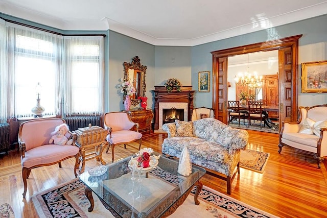 living room with hardwood / wood-style flooring, plenty of natural light, and a notable chandelier