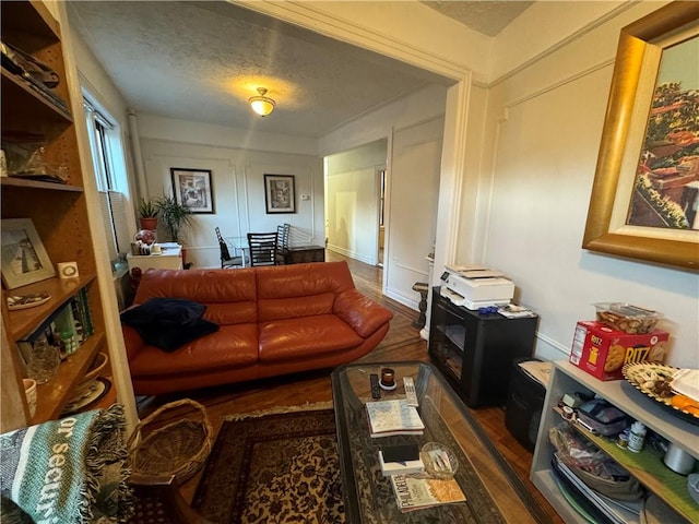 living room with dark hardwood / wood-style flooring and a textured ceiling