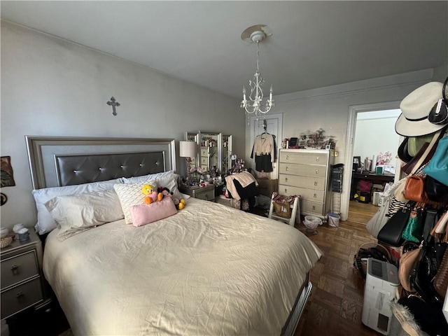 bedroom featuring dark parquet floors and a chandelier