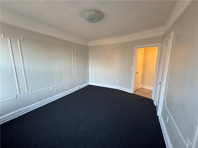 carpeted spare room featuring a textured ceiling