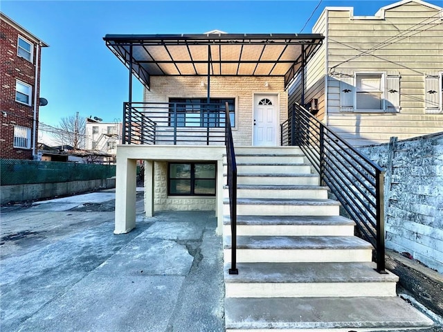 view of exterior entry with a carport