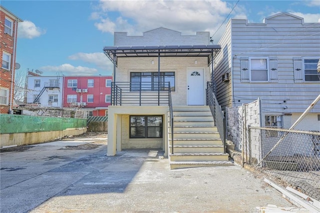 view of front of property with fence and stairway